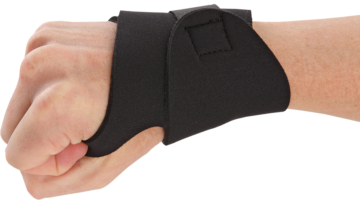 A hand with a black wrist wrap on
