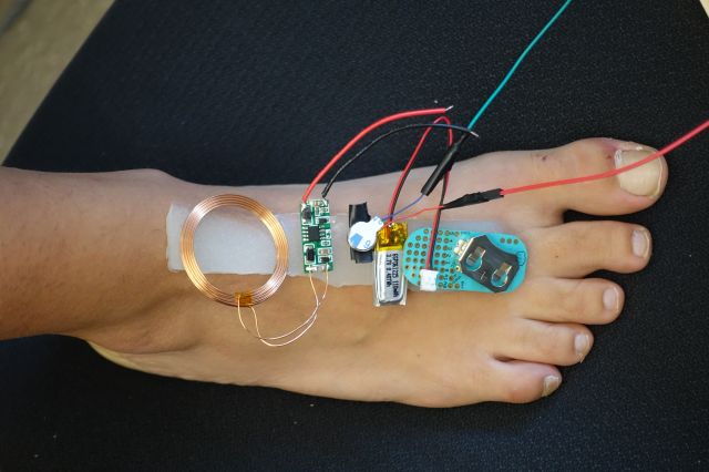 A foot covered in electronics