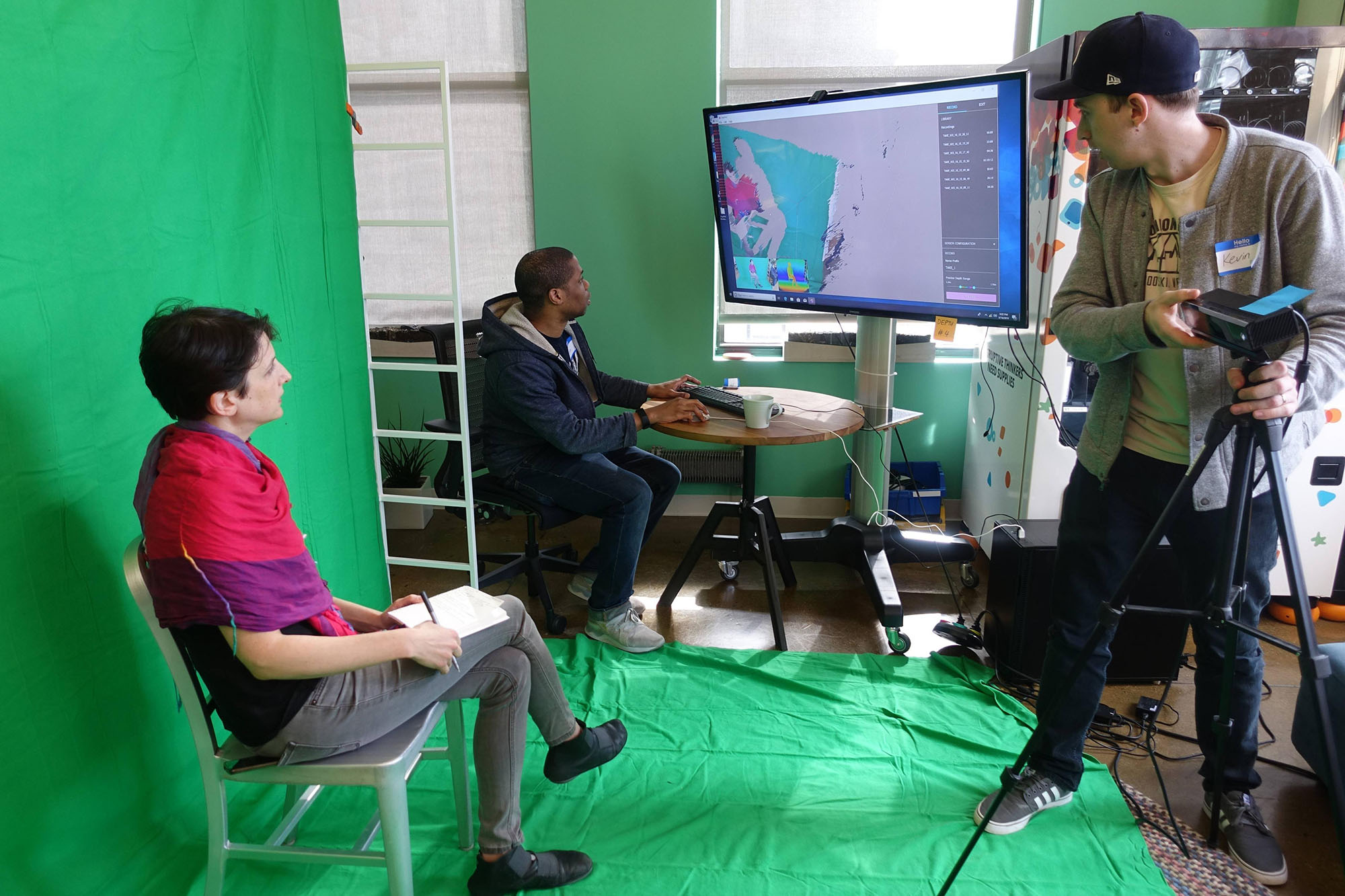 A video team in front of a green screen
