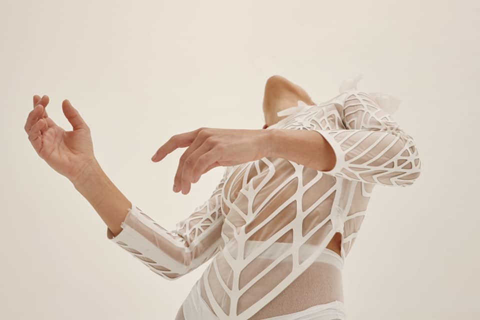 Person bent backwards with a white lace dress