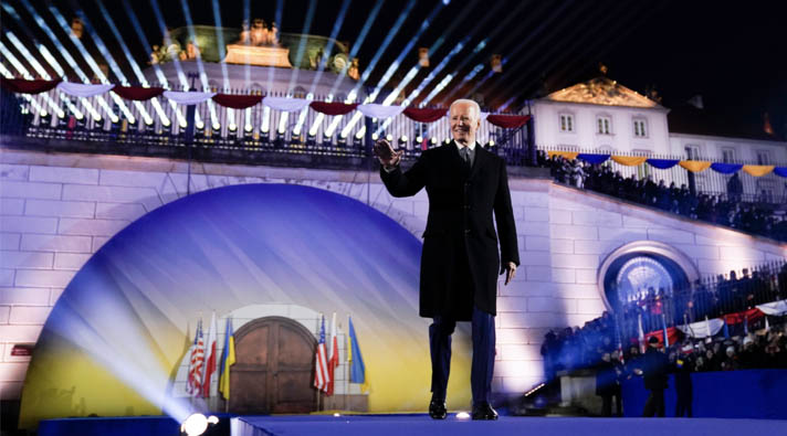 President Biden on a stage waving at the audience