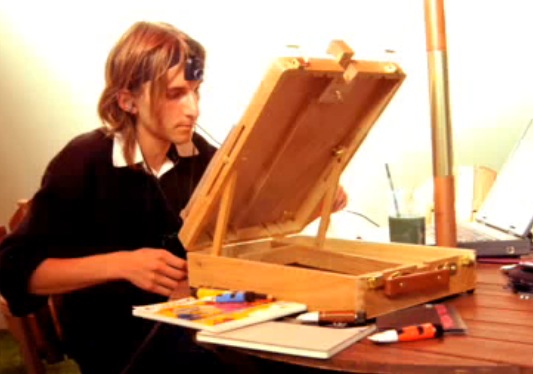 Neil Harbisson with a bulky webcam strapped to his head by velcro