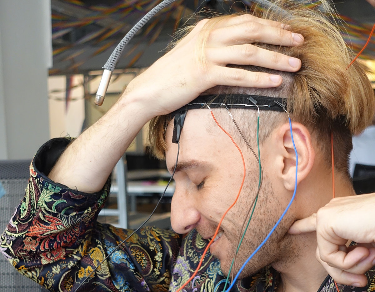 Neil wears a headband prototype with wires coming out of it
