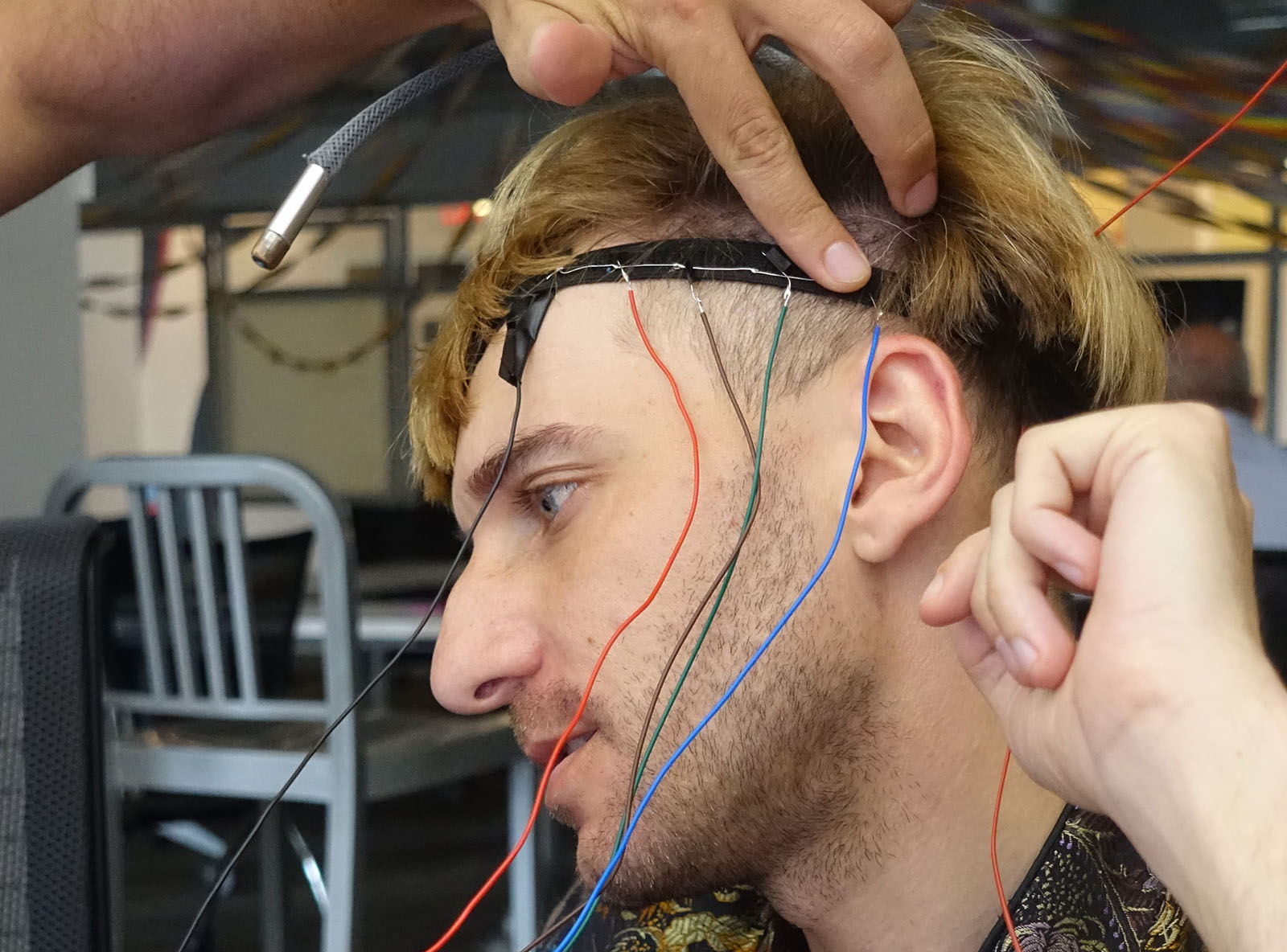 Neil Harbisson wearing a headand with wires coming out of it