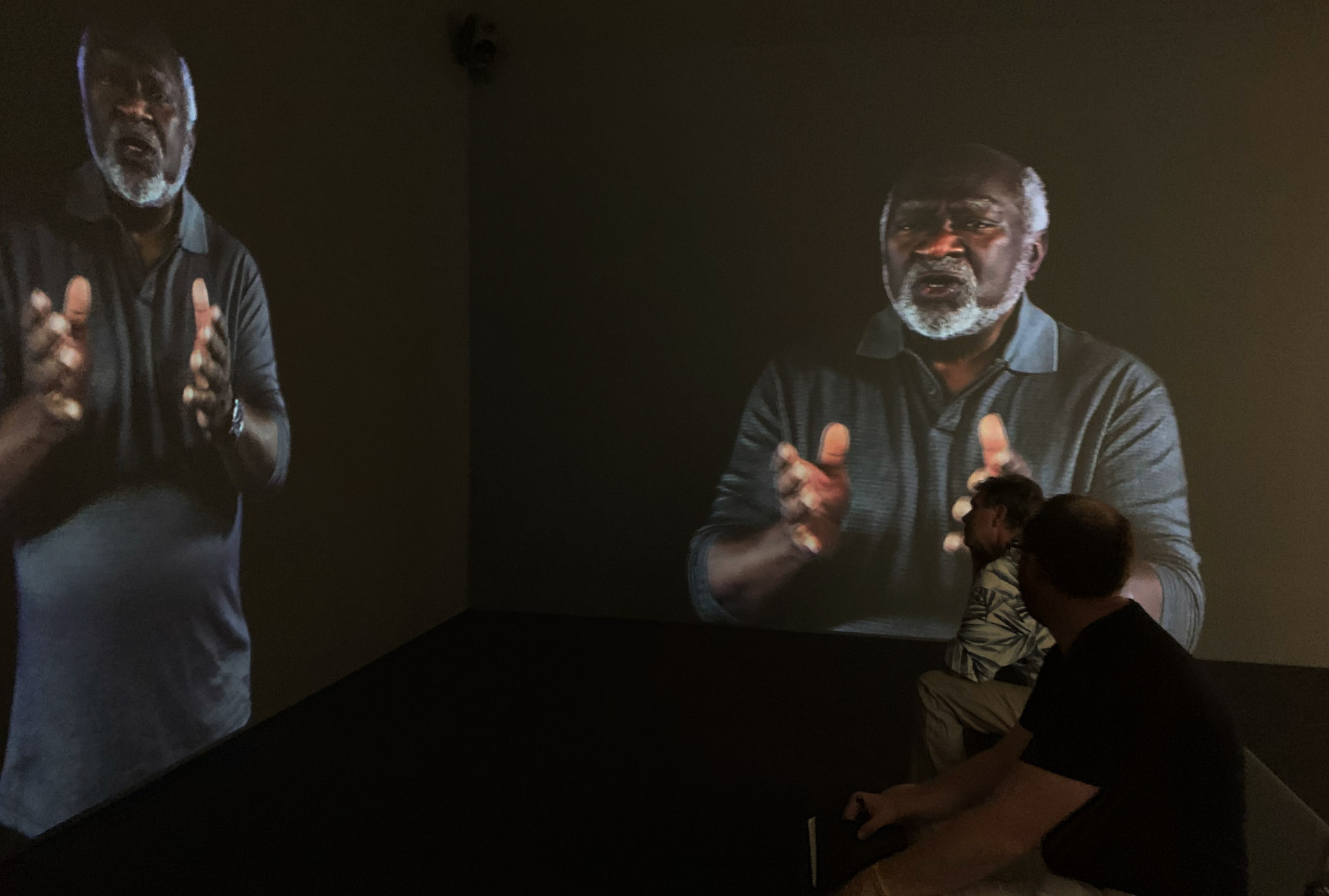 Installation shot showing a man singing