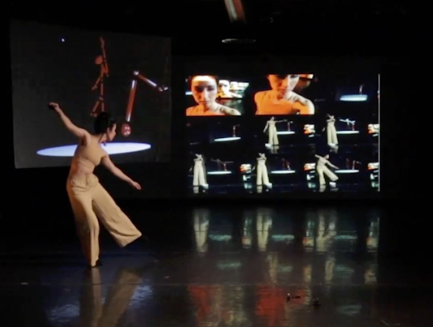 Catie dancing in front of a screen with multiple time-lapsed versions of her live performance