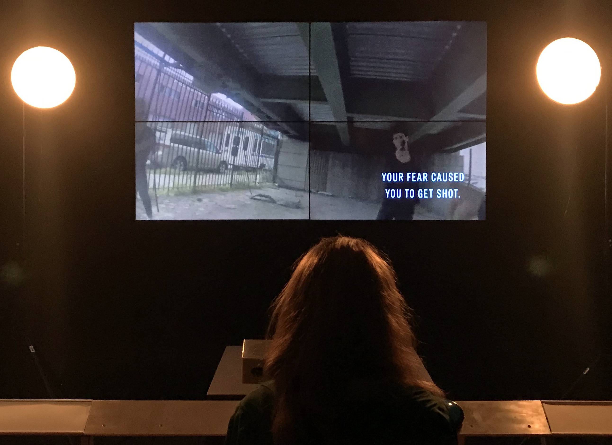 A woman watching the video experience in a dark room