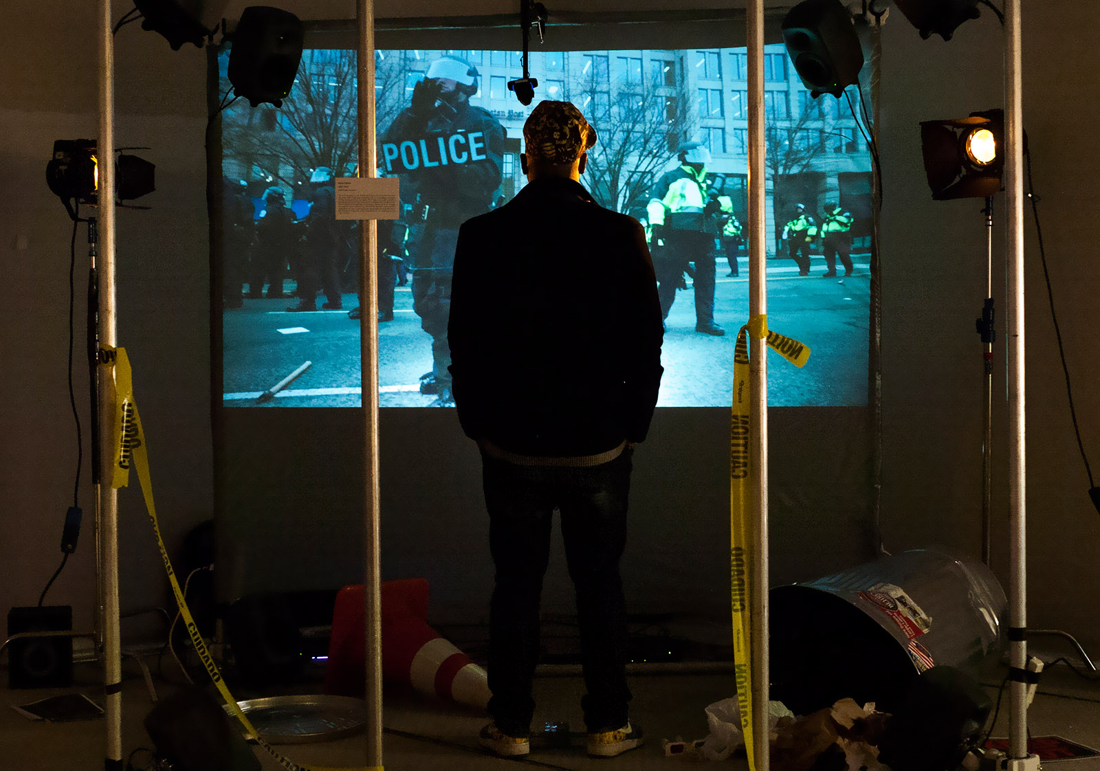An audience member standing in front of the installation in a dark room